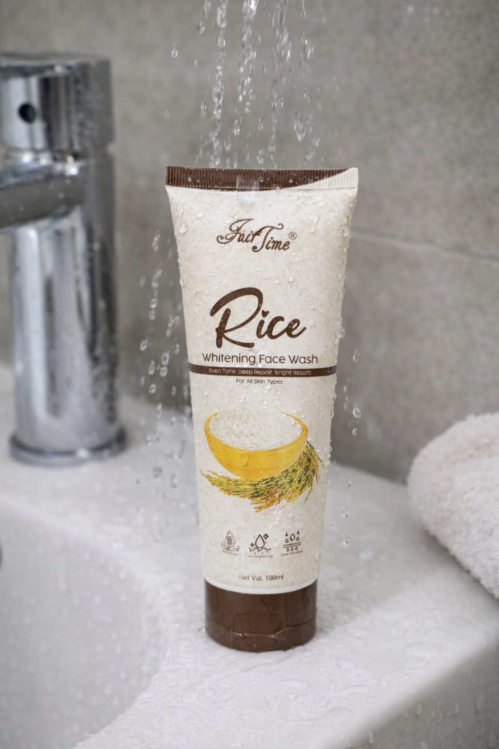 Tube of rice whitening face wash on a sink with water flowing