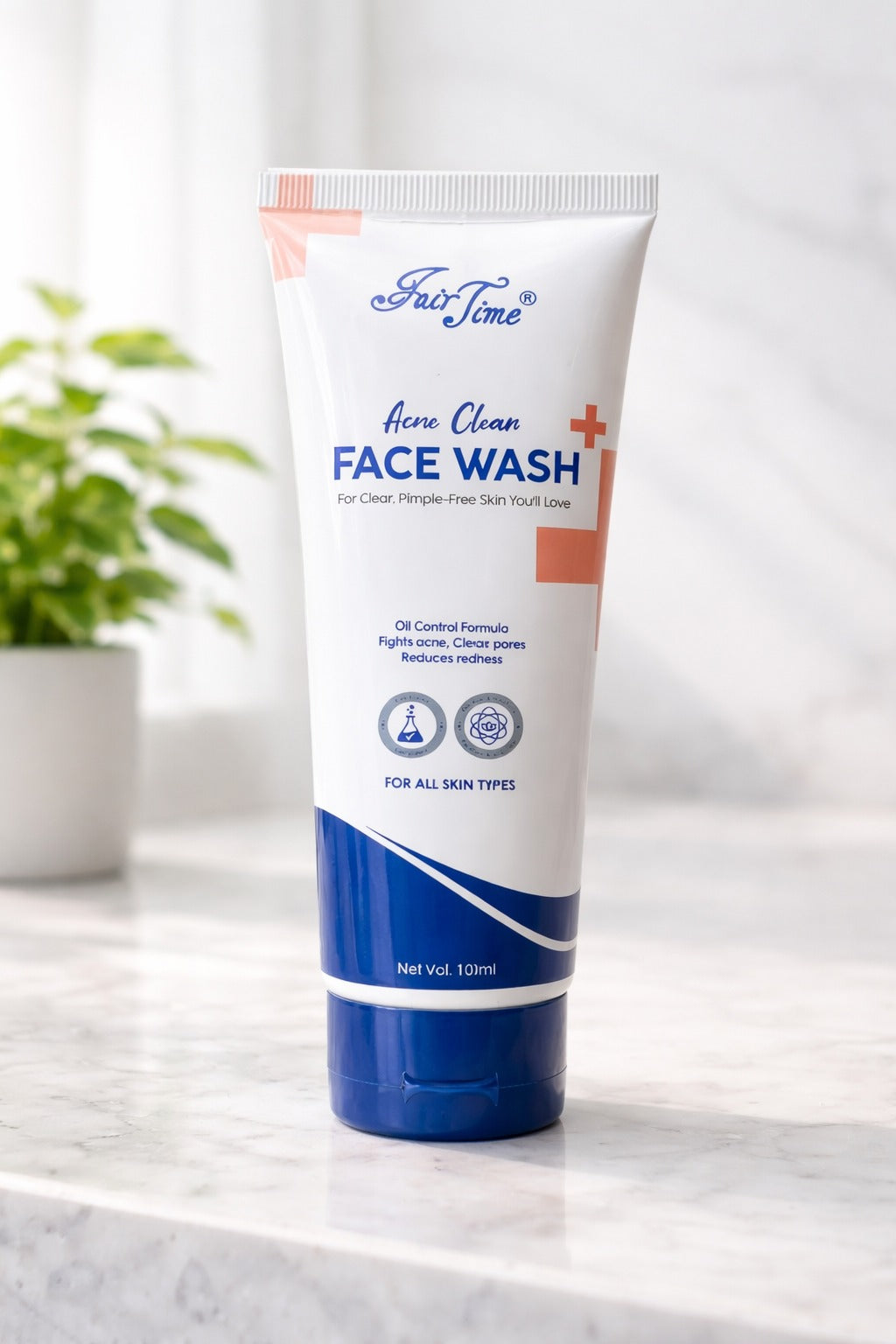Tube of Face Wash on a marble surface with a plant in the background
